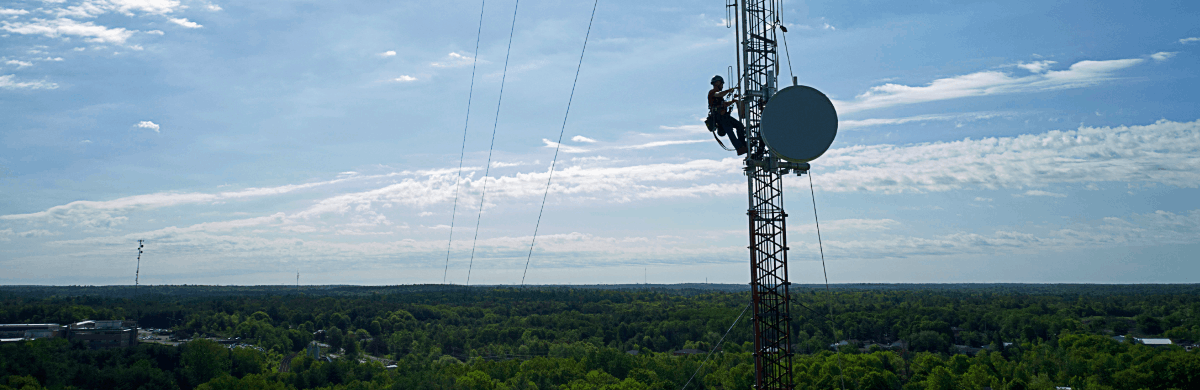 Vianet communication tower maintenance with aerial view of the city