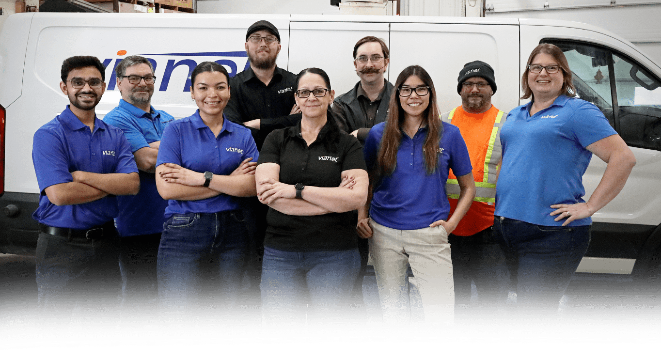 Vianet staff stand in front of a white van.