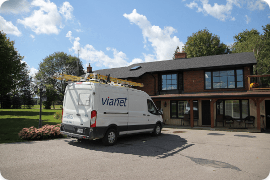 A Vianet service vehicle parked in front of a house.
